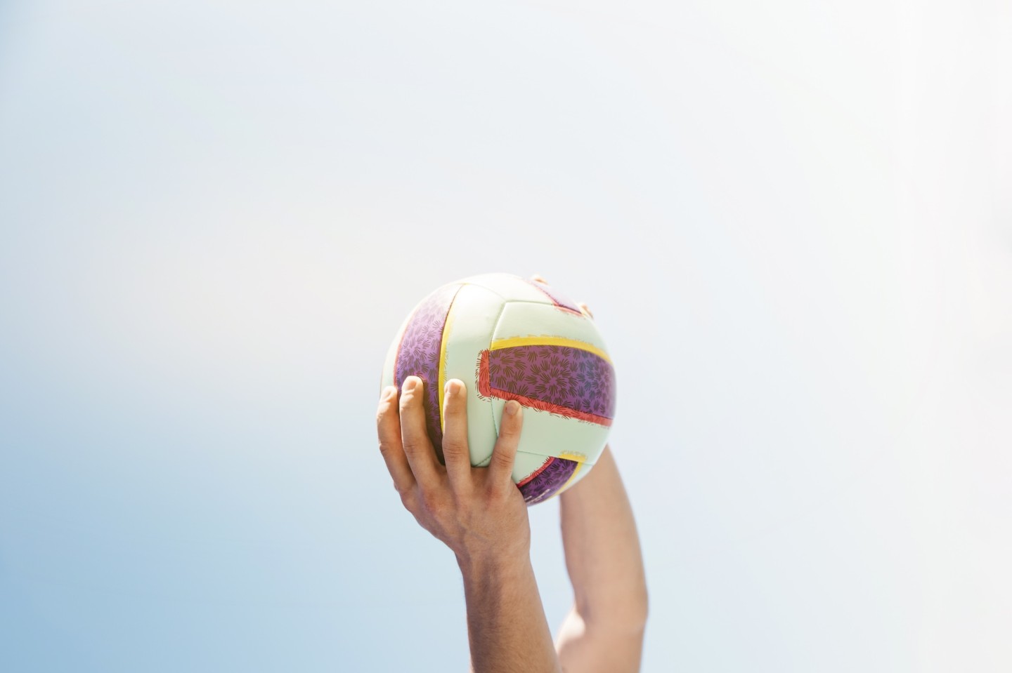man-holding-football-sky-background