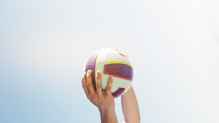 man-holding-football-sky-background