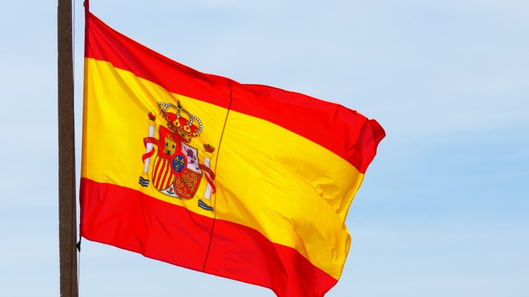 Flying Spain flag over sky background Flying Spain flag